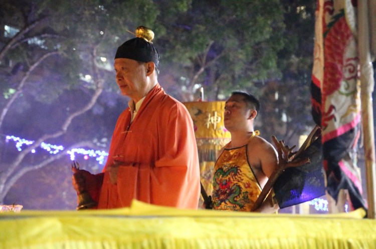 The Taoist priest, together with the Nine Emperor Gods spirit medium performing the ritual to raise the Nine Lamps.