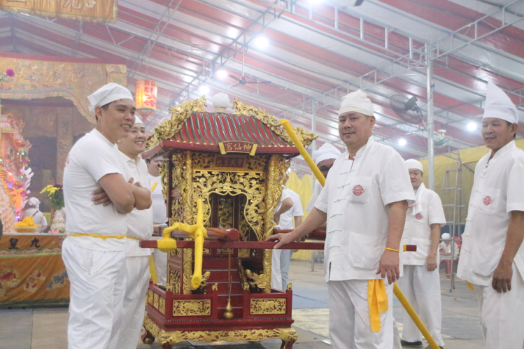 Other helpers of the temple get ready to move out to Changi Beach for the receiving.
